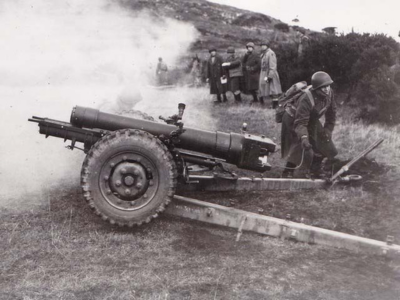 105MM artillery being fired on an artillery range.