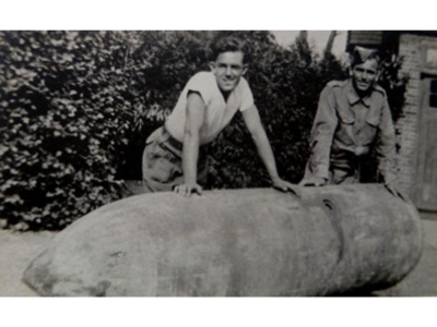 Soldiers rest on one of the largest bombs dropped on Northern Ireland, an SC 1800 'Satan' which fell on Bangor.