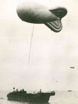 A barrage balloon tethered to a barge in Belfast Lough