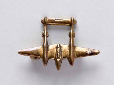 A P-38 Lightning lapel pin from the Lockheed Overseas Corporation based a Langford Lodge from the collection here at NIWM